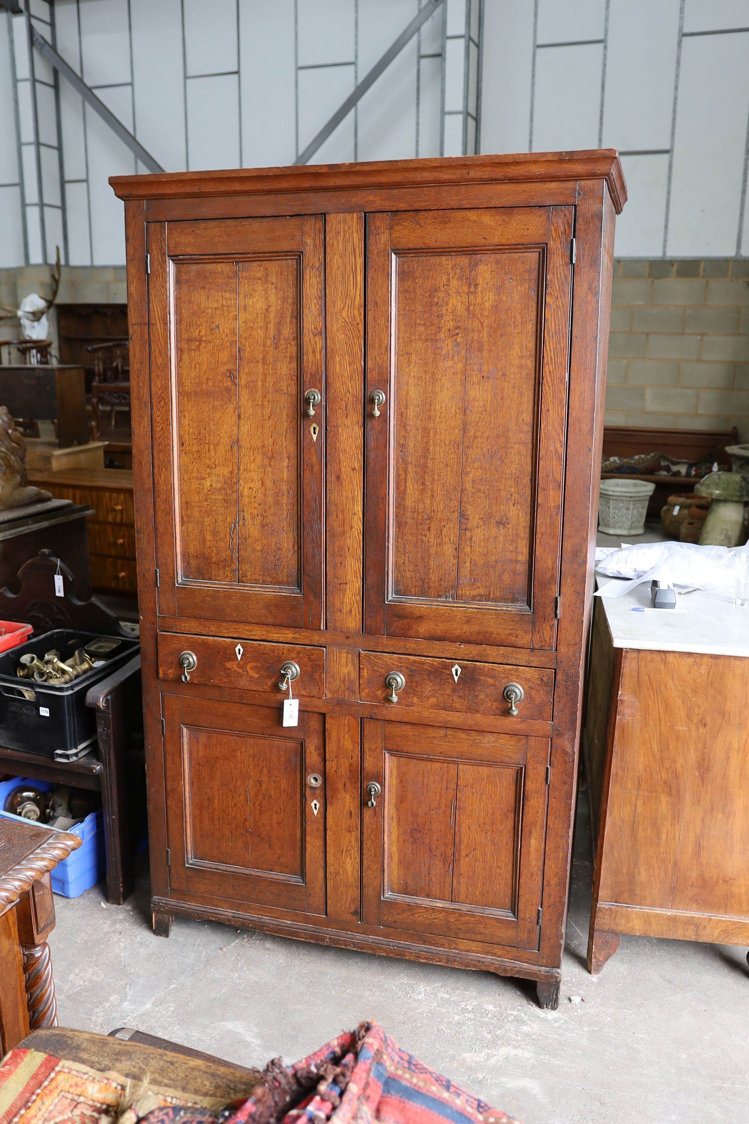 An early 19th century Welsh panelled oak household cabinet. W 116cm, D 52cm, H 200cm